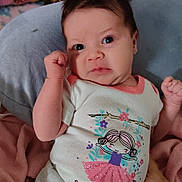 Kiana is registered to the contest to win money with this photo: baby, bed, blanket, child, clothing, cute, expression, face, fist, gray, hand, indoors, infant, newborn, person, pillow, pink, portrait, sleepwear, white
