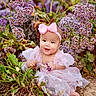 baby, infant, child, pink_dress, headband, bow, flowers, purple_flowers, outdoor, nature, plants, greenery, cute, smiling, sitting, ground, portrait, garden, floral, happy