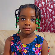 Lea participe au concours pour gagner de l'argent avec cette photo : child, girl, braids, beads, dress, floral_pattern, couch, indoor, portrait, face, calm, seated, furniture, curtain, pattern, colorful, person, young, hairstyle, casual
