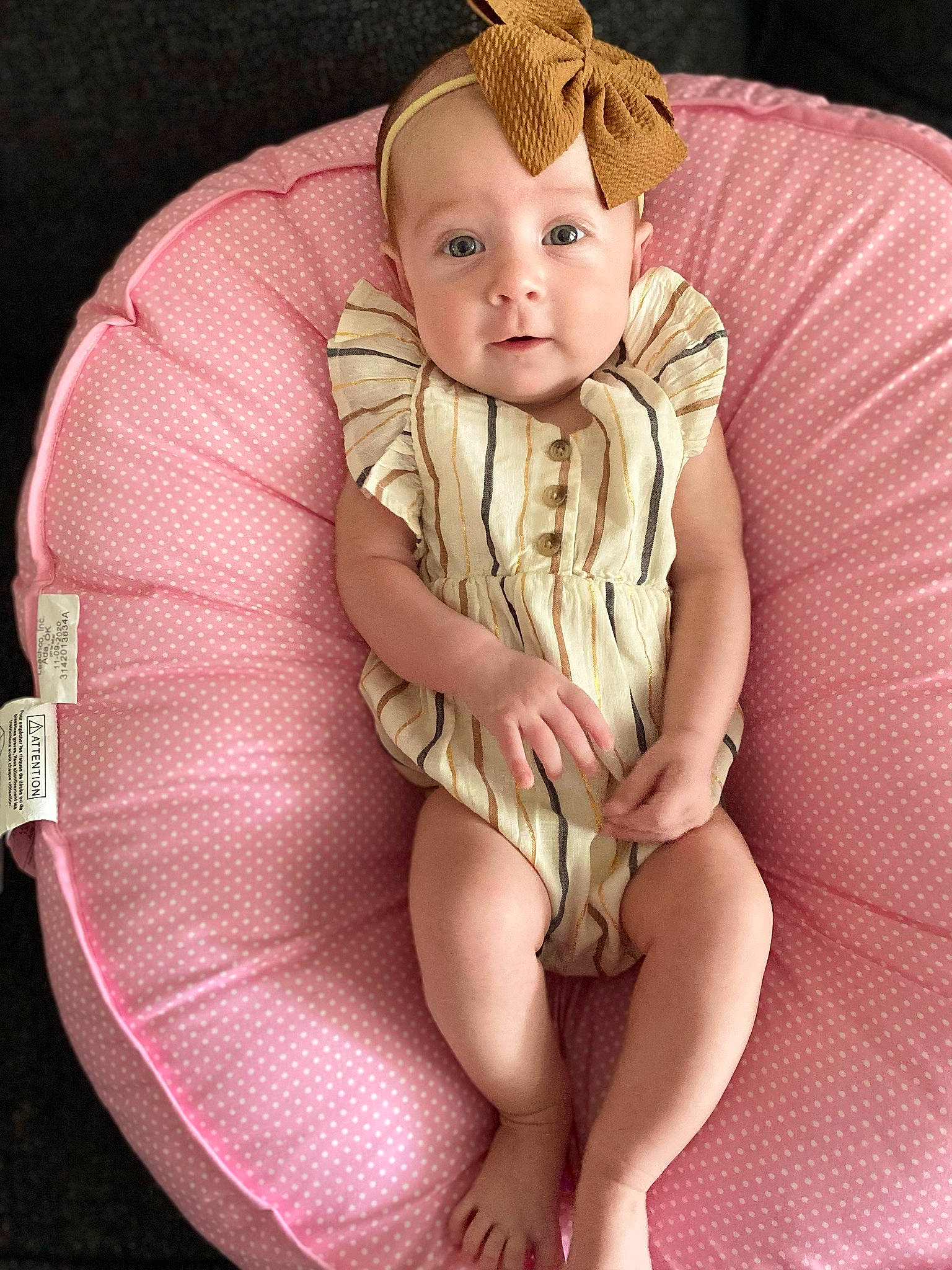 Landry is registered to the contest to win money with this photo: baby, baby_toddler_clothing, cheek, comfort, eye, face, finger, head, human_body, human_leg, iris, jewellery, knee, lap, leg, person, pink, skin, sleeve, thigh