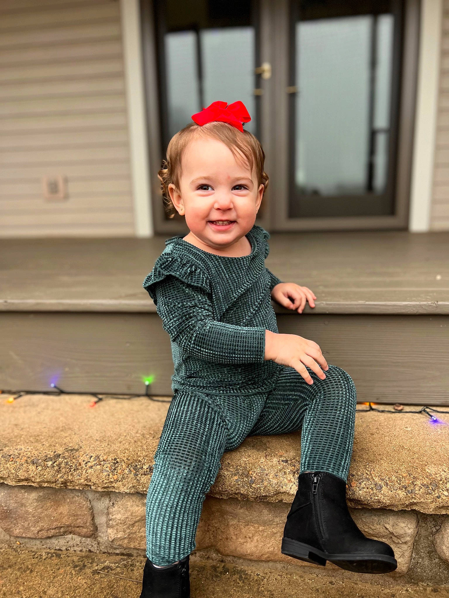 Landry is registered to the contest to win money with this photo: baby_toddler_clothing, dress, face, flash_photography, flooring, formal_wear, happy, hat, head, human_leg, joy, knee, leg, pattern, person, sitting, sleeve, smile, standing, toddler