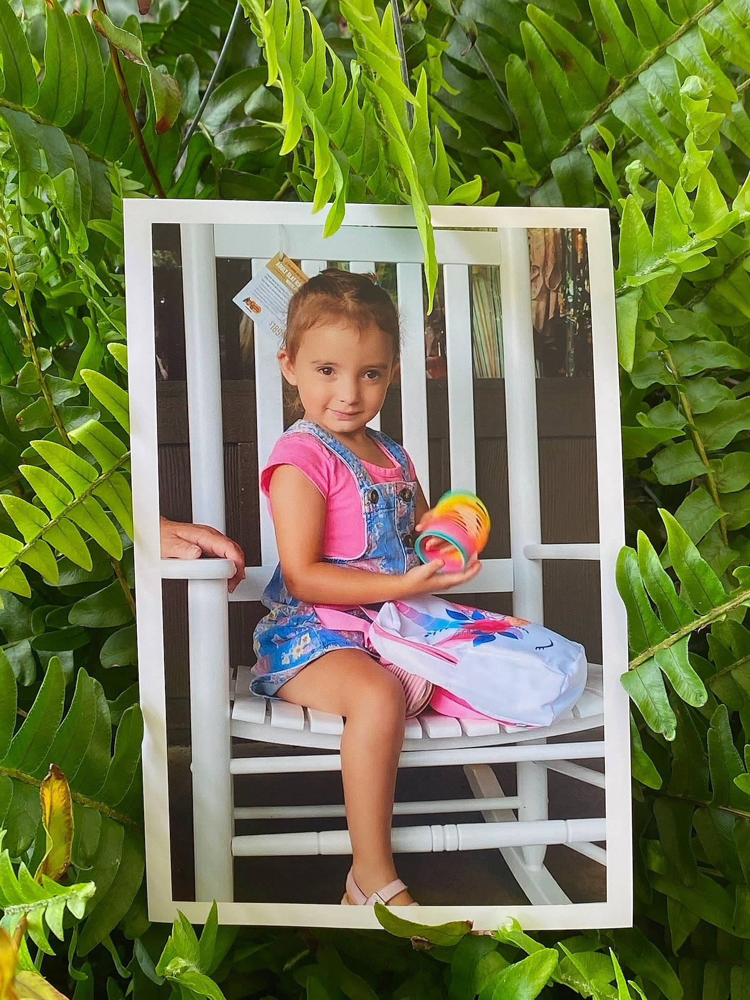 Baylee is registered to the contest to win money with this photo: baby_toddler_clothing, chair, child, garden, grass, green, happy, joy, leg, leisure, outdoor_furniture, people_in_nature, person, plant, sandal, shorts, summer, t_shirt, terrestrial_plant, thigh