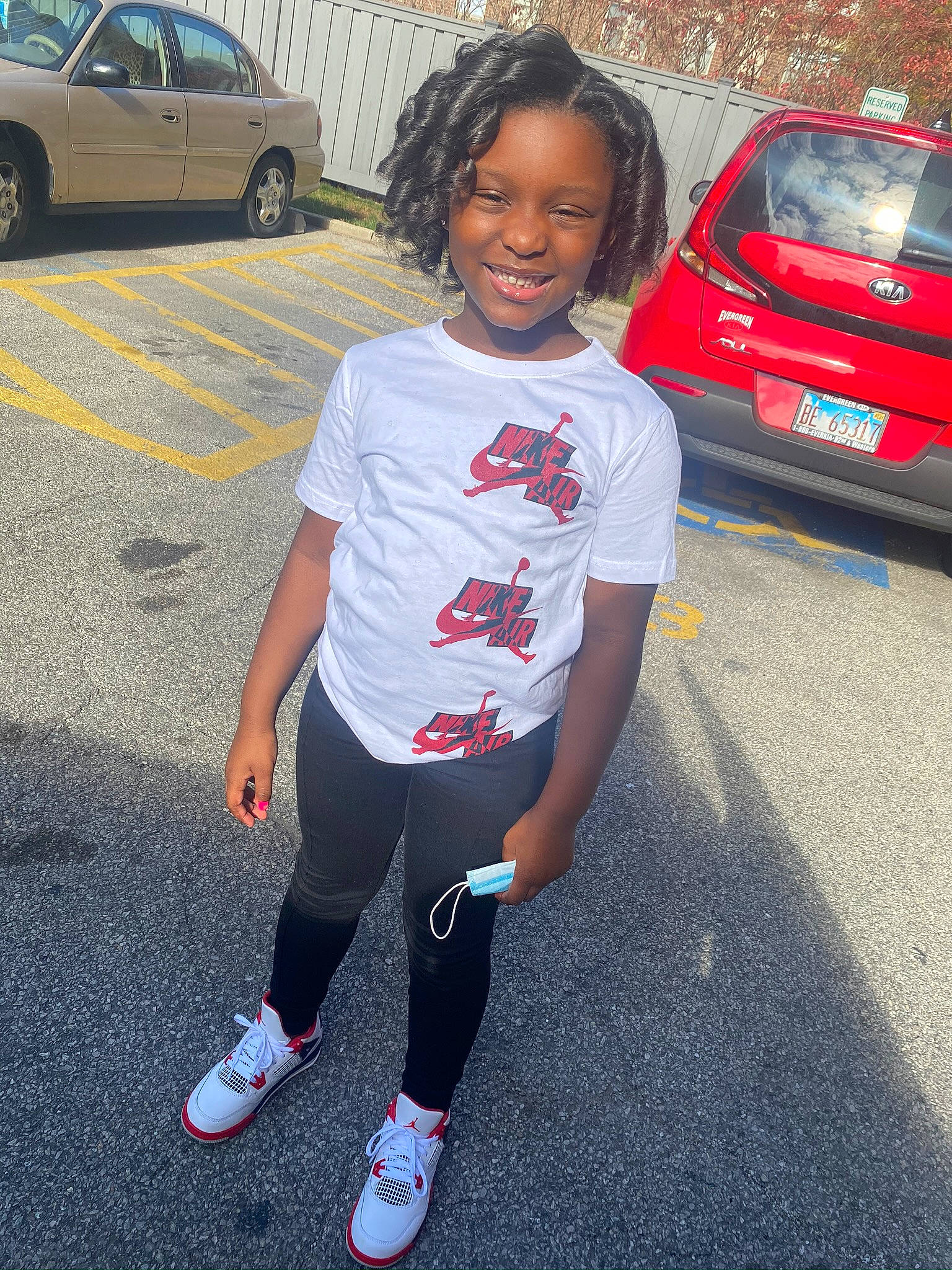 Emani is registered to the contest to win money with this photo: asphalt, automotive_design, automotive_exterior, automotive_lighting, automotive_tire, bumper, car, electric_blue, joy, land_vehicle, light, mode_of_transport, motor_vehicle, parking, person, road, snapshot, street_fashion, tire, toddler