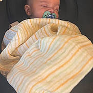 Jake is registered to the contest to win money with this photo: baby, infant, sleeping, pacifier, blanket, striped_blanket, car_seat, child, portrait, indoors, cozy, resting, closed_eyes, bald, head, face,  안전, nursery, travel, nap