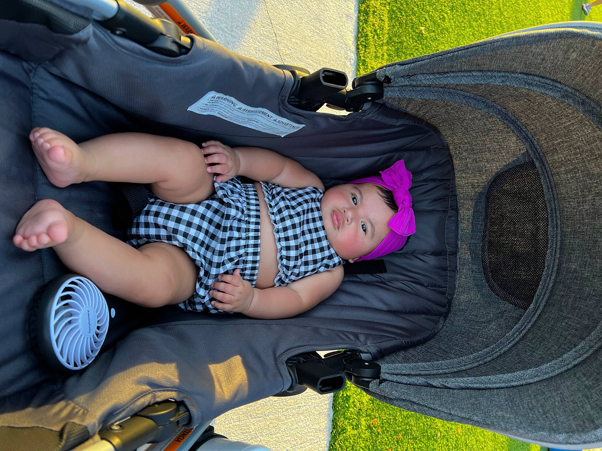 Liyana is registered to the contest to win money with this photo: baby_carriage, baby_toddler_clothing, bag, child, cool, fashion, fun, headgear, headwear, lap, leg, luggage_and_bags, pattern, people, person, product, purple, shoe, sneakers, thigh