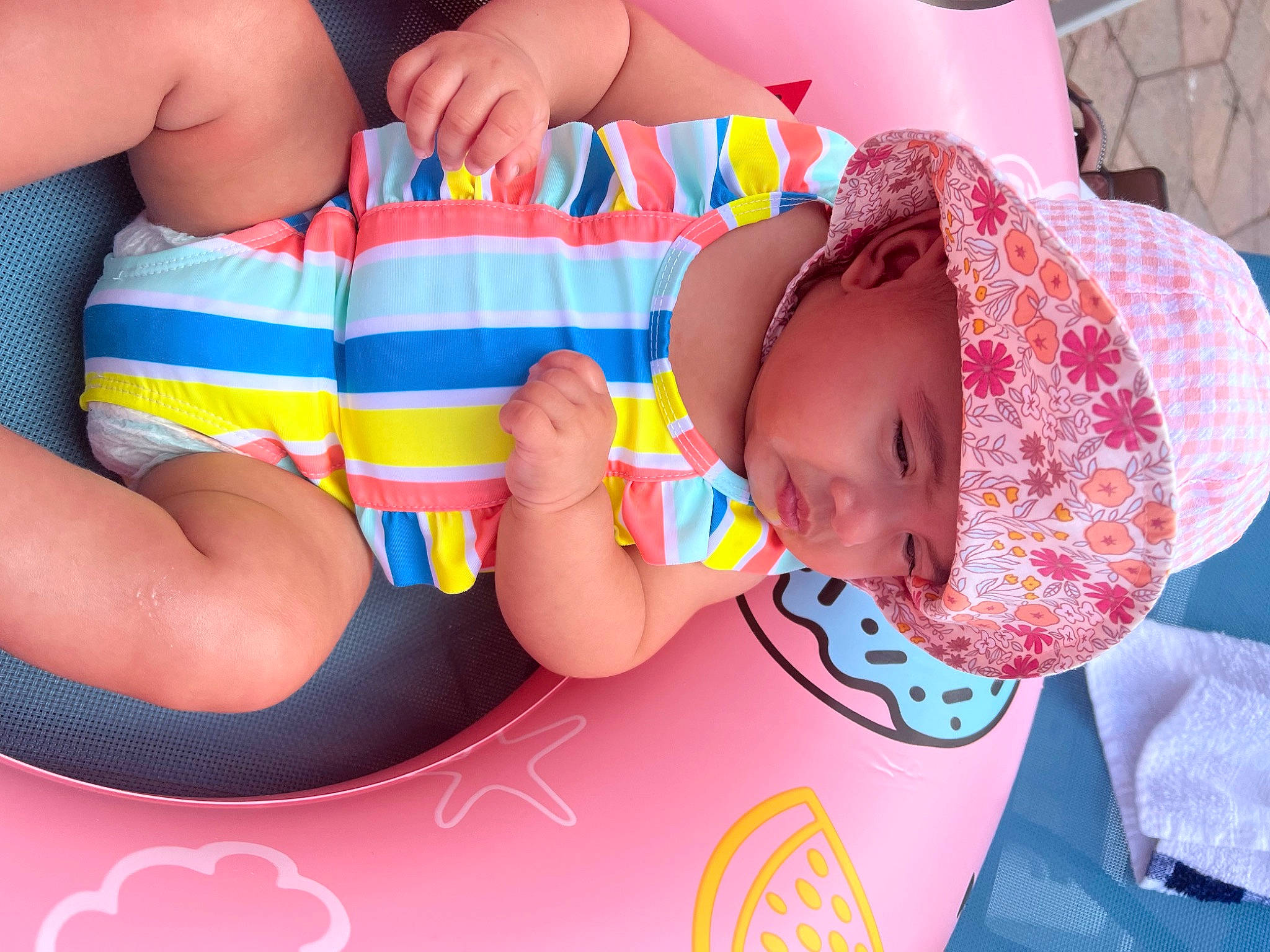 Liyana is registered to the contest to win money with this photo: baby, baby_products, baby_toddler_clothing, child, facial_expression, finger, fun, happy, head, headwear, human_leg, leisure, mouth, nail, orange, pattern, person, pink, product, skin