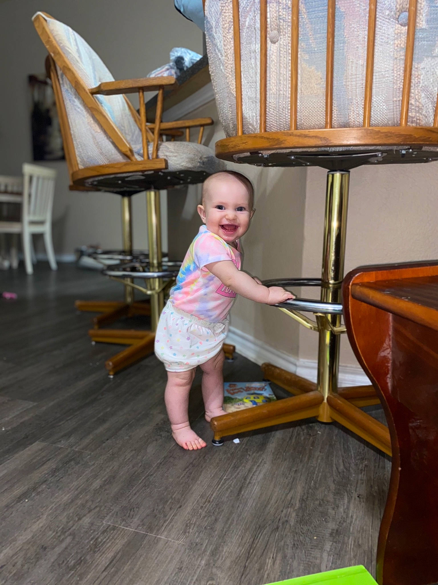 Harlee is registered to the contest to win money with this photo: beauty, chair, child, comfort, floor, flooring, furniture, green, hardwood, house, joy, leisure, outdoor_furniture, person, product, sitting, smile, toddler, tree, varnish