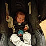 baby, infant, car_seat, evenflo, pajamas, pacifier, stripes, fabric, seatbelt, child, indoor, newborn, person, cute, small, furniture, safety, resting, clothing, young