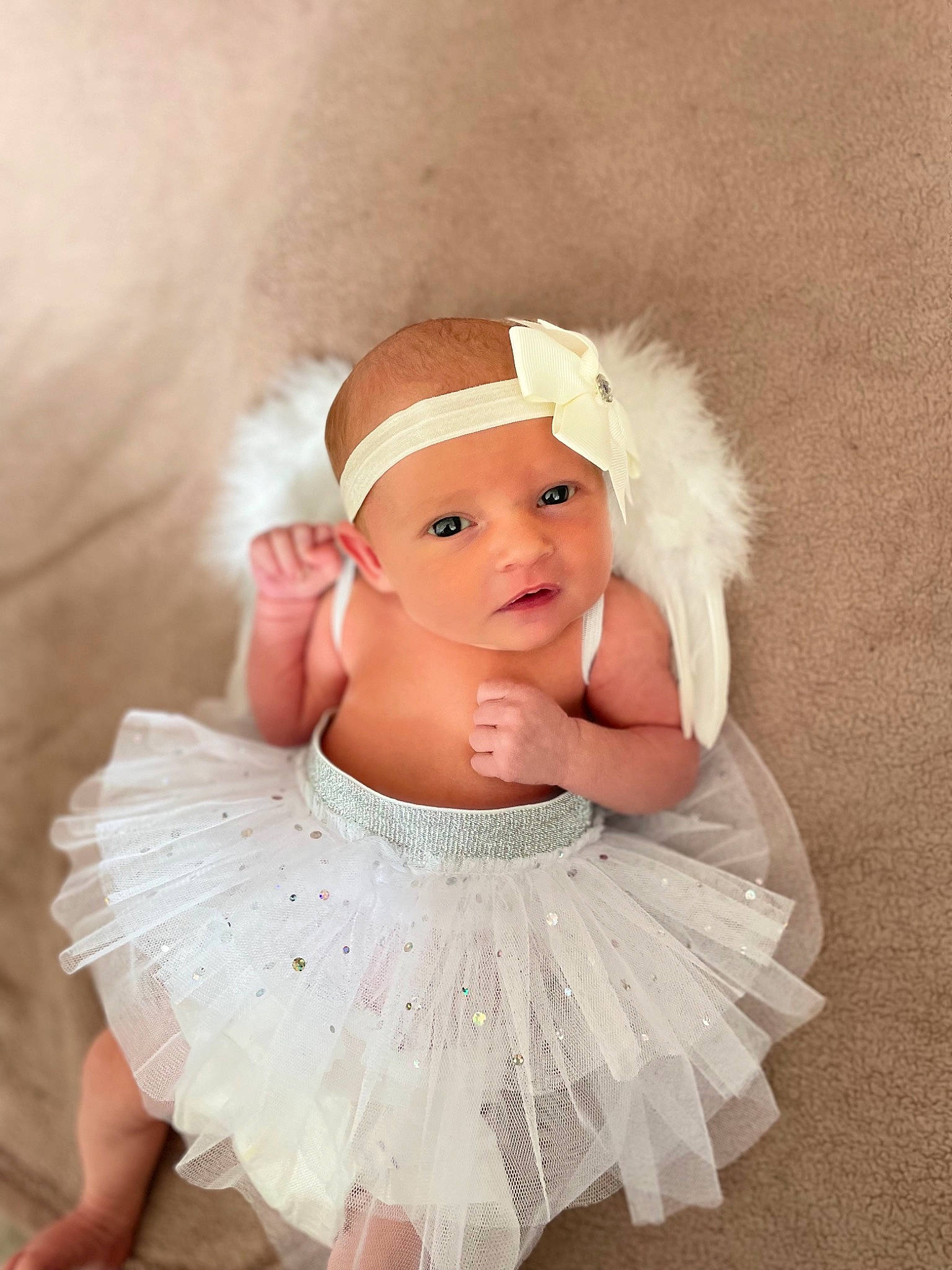 Gracie-mai is registered to the contest to win money with this photo: baby, baby_toddler_clothing, bridal_accessory, cap, costume_hat, dress, embellishment, eye, flash_photography, hair_accessory, happy, head, headband, headgear, headpiece, headwear, human_body, iris, person, petal