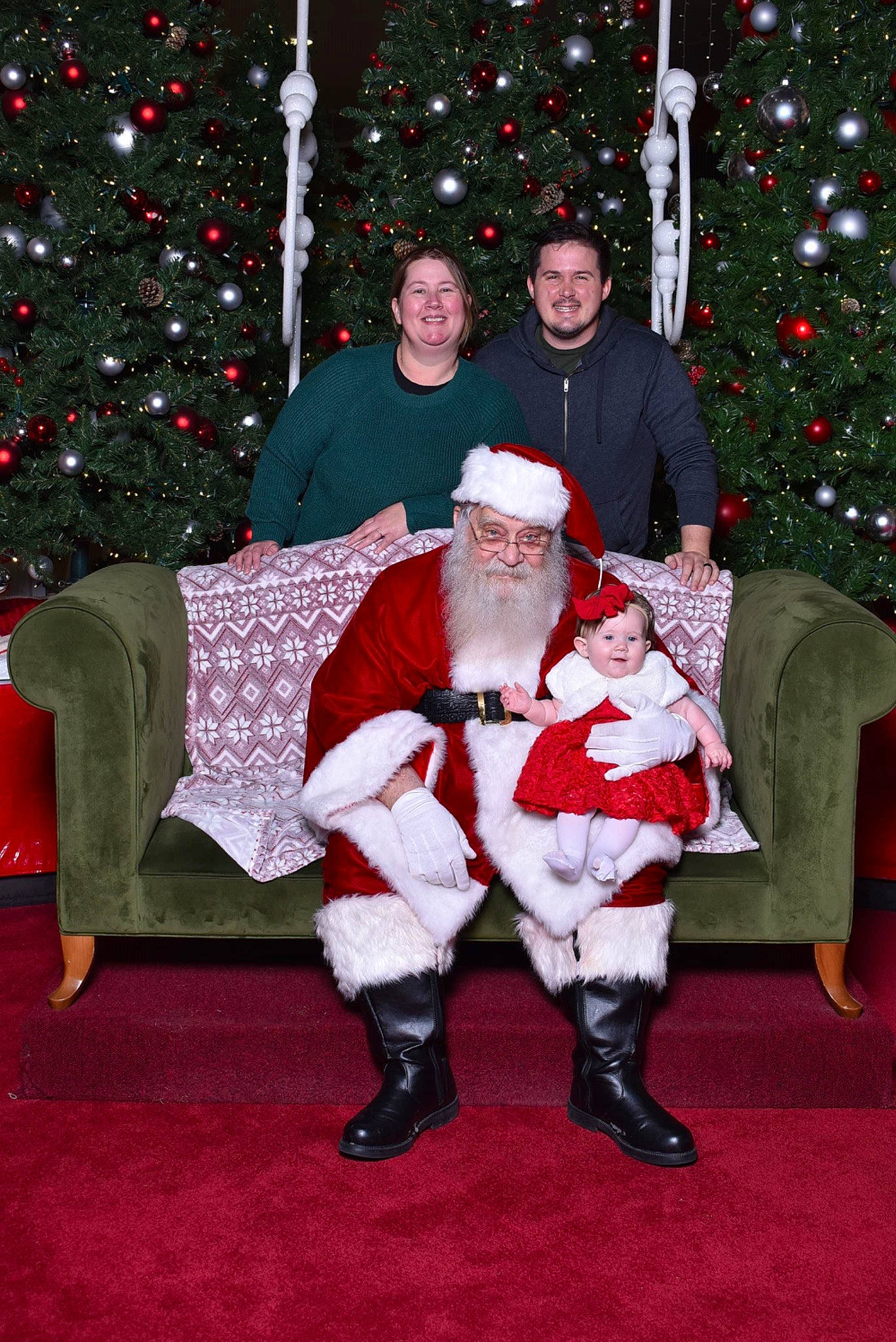 Madilyn joined the competition — help win amazing prizes! christmas, christmas_decoration, christmas_ornament, christmas_tree, event, fun, green, hat, headwear, holiday, holiday_ornament, human_body, joy, lap, organ, person, photograph, red, smile, snapshot