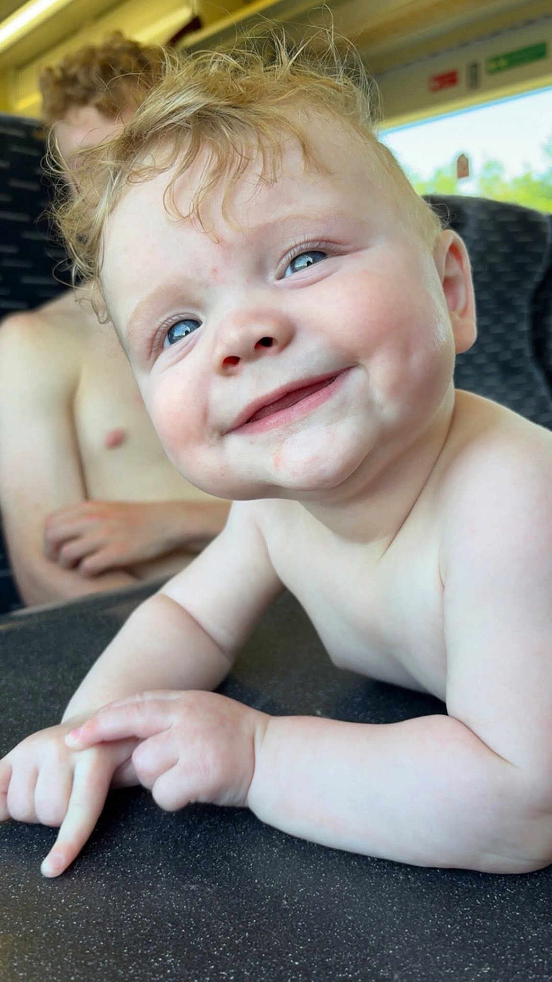 Kyro joined the competition — help win amazing prizes! baby, child, smiling, curly_hair, blue_eyes, close_up, portrait, happy, skin, hands, table, indoor, seat, window, background, person, sibling, natural_light, face, cute
