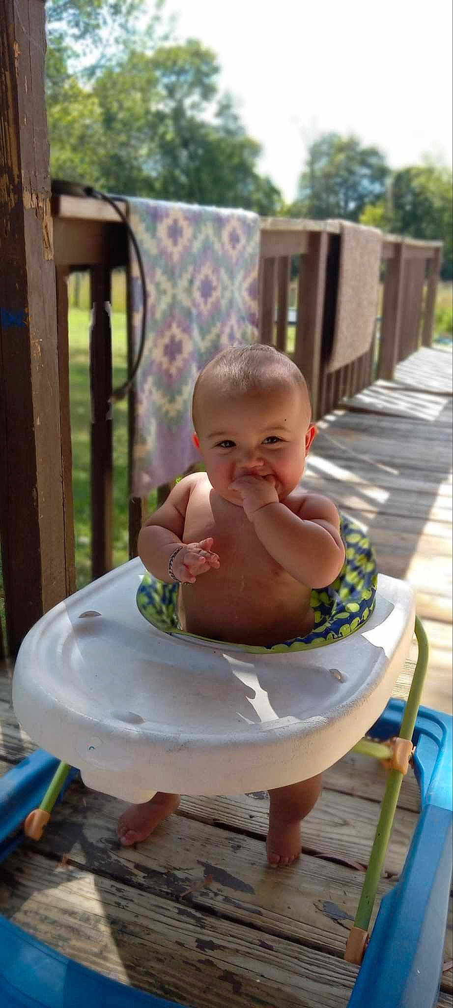 Dawson is registered to the contest to win money with this photo: baby, baby_products, baby_toddler_clothing, barefoot, chair, chest, child, foot, fun, grass, happy, head, human_leg, leisure, person, recreation, sitting, thigh, thumb, toddler