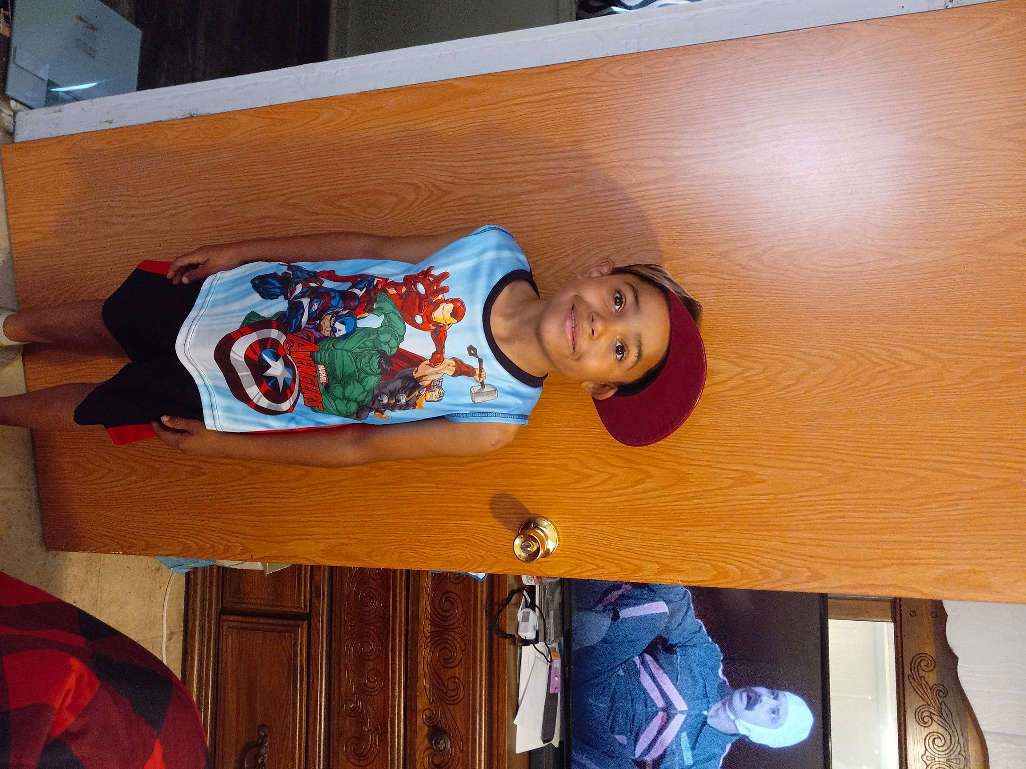 Denzel joined the competition — help win amazing prizes! carmine, child, comfort, flooring, fun, hardwood, hat, headwear, home, joy, person, room, sitting, t_shirt, textile, wood, wood_stain