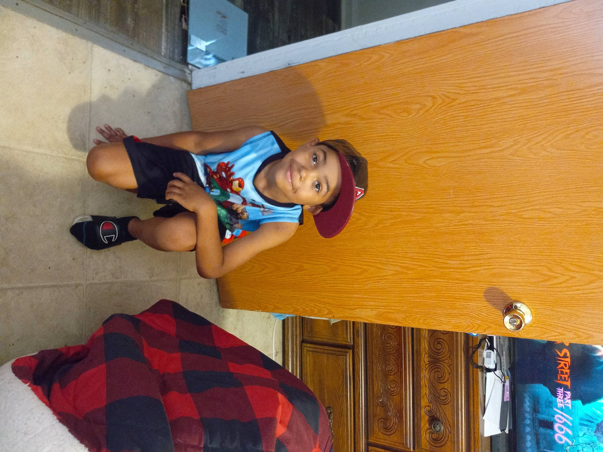 Denzel joined the competition — help win amazing prizes! blue, child, elbow, electric_blue, flooring, fun, happy, hardwood, headwear, human_leg, joy, knee, leisure, person, plaid, sandal, shorts, smile, t_shirt, tartan