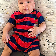 Liam joined the competition — help win amazing prizes! baby, infant, child, romper, striped_clothing, pillow, animal_print, elephant, giraffe, horse, hedgehog, smiling, cute, chubby_cheeks, indoors, portrait, person, hand, legs, sitting