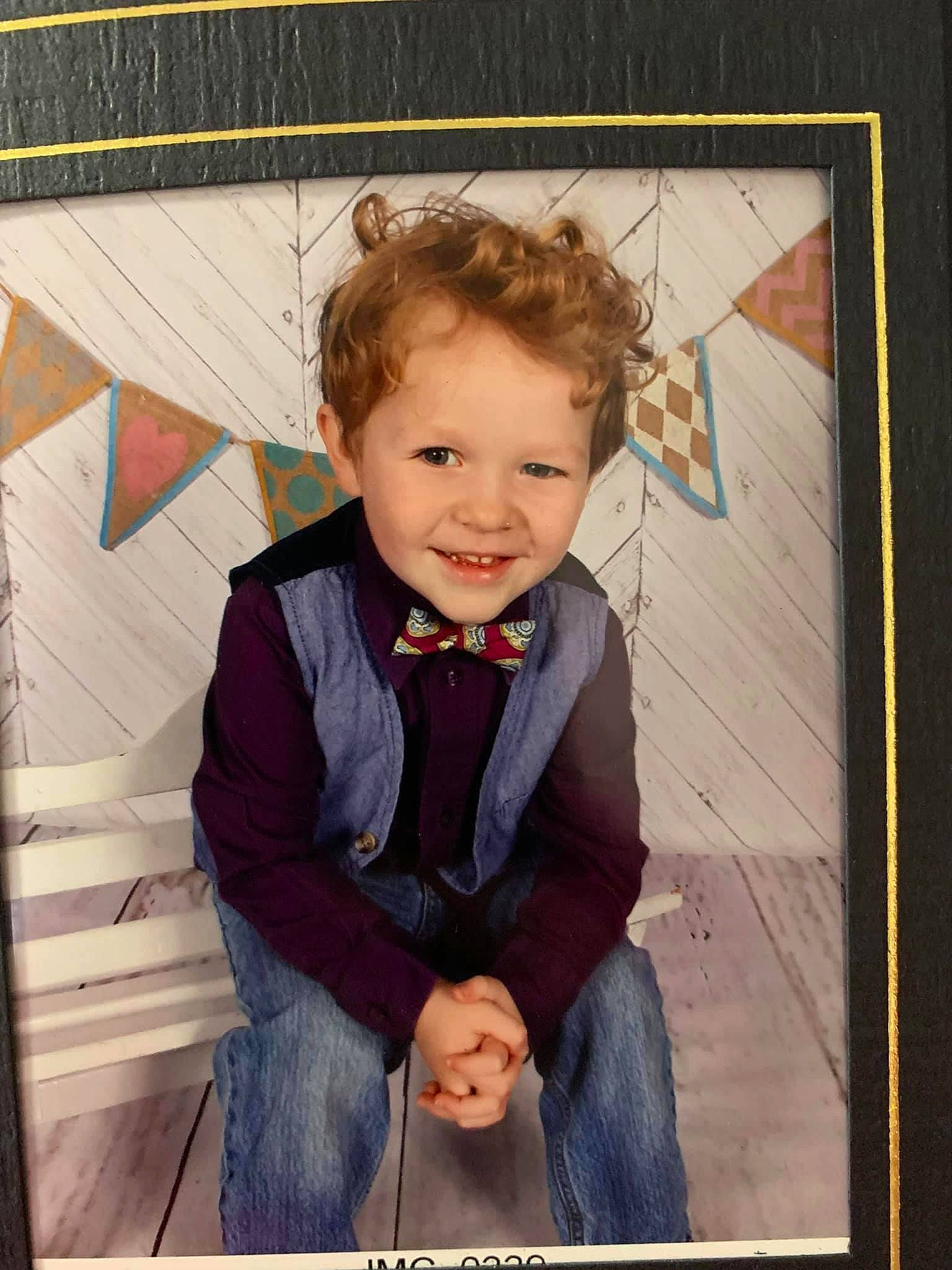 Grayson is registered to the contest to win money with this photo: beauty, cheek, child, collar, denim, dress_shirt, flash_photography, fun, happy, joy, pattern, person, picture_frame, portrait_photography, rectangle, room, sitting, sleeve, smile, tie