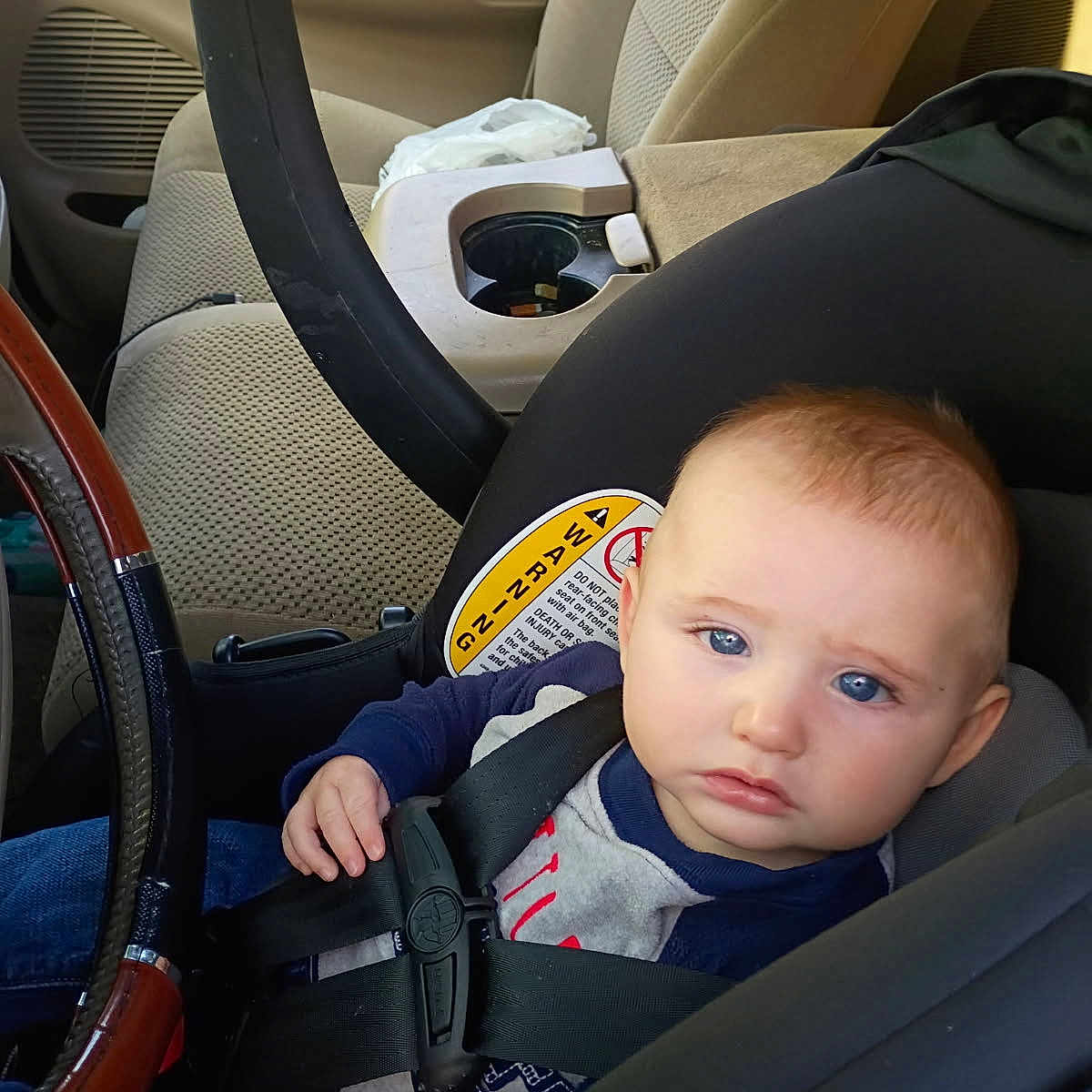 Jace Tyler Wylie joined the competition — help win amazing prizes! baby, baby_face, blue_eyes, car, car_seat, child, child_in_car, child_safety, clothing, indoor, infant, person, safety_harness, seat, seatbelt, serious_expression, steering_wheel, transportation, vehicle_interior, young_child
