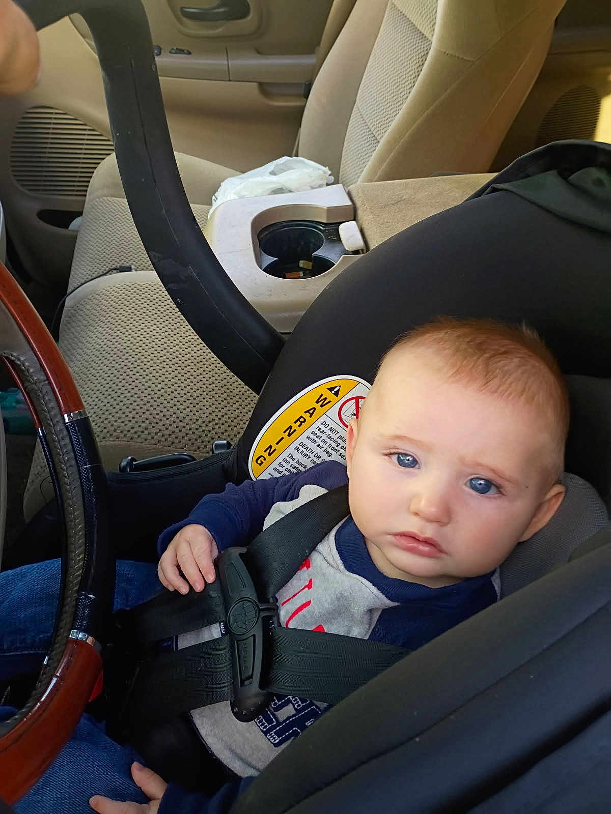 Jace Tyler Wylie joined the competition — help win amazing prizes! baby, car_seat, child, blue_eyes, seatbelt, vehicle_interior, steering_wheel, serious_expression, infant, clothing, safety_harness, person, car, seat, child_safety, young_child, baby_face, indoor, transportation, child_in_car