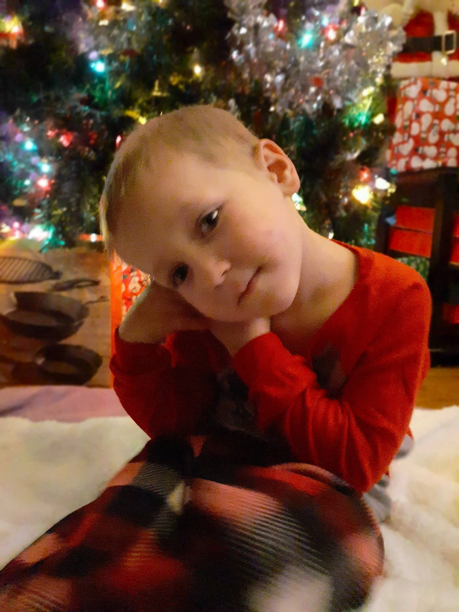 Tyson is registered to the contest to win money with this photo: baby, child, christmas, christmas_decoration, christmas_eve, christmas_ornament, christmas_tree, head, holiday, person, smile, toddler