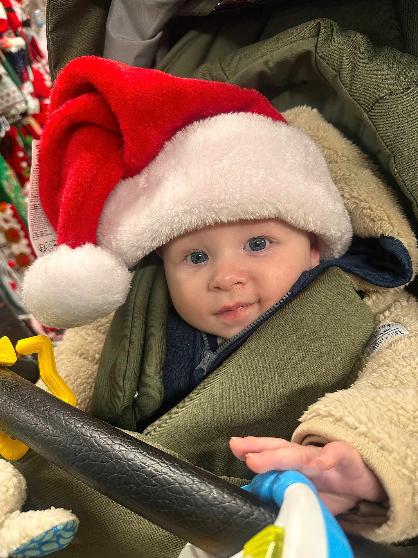 Levi joined the competition — help win amazing prizes! baby, blue_eyes, child, childhood, clothing, cozy, cute, face, festive, happy, holiday, infant, portrait, santa_hat, seasonal, smiling, stroller, toy, warm, winter_clothing
