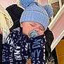 Fin joined the competition — help win amazing prizes! baby, sleeping, pacifier, blue_hat, pom_poms, blue_outfit, text_print, hands, adult, indoor, staircase, pink_wall, cozy, child, person, sleep, knit_hat, cuddly, warm_clothing, infant