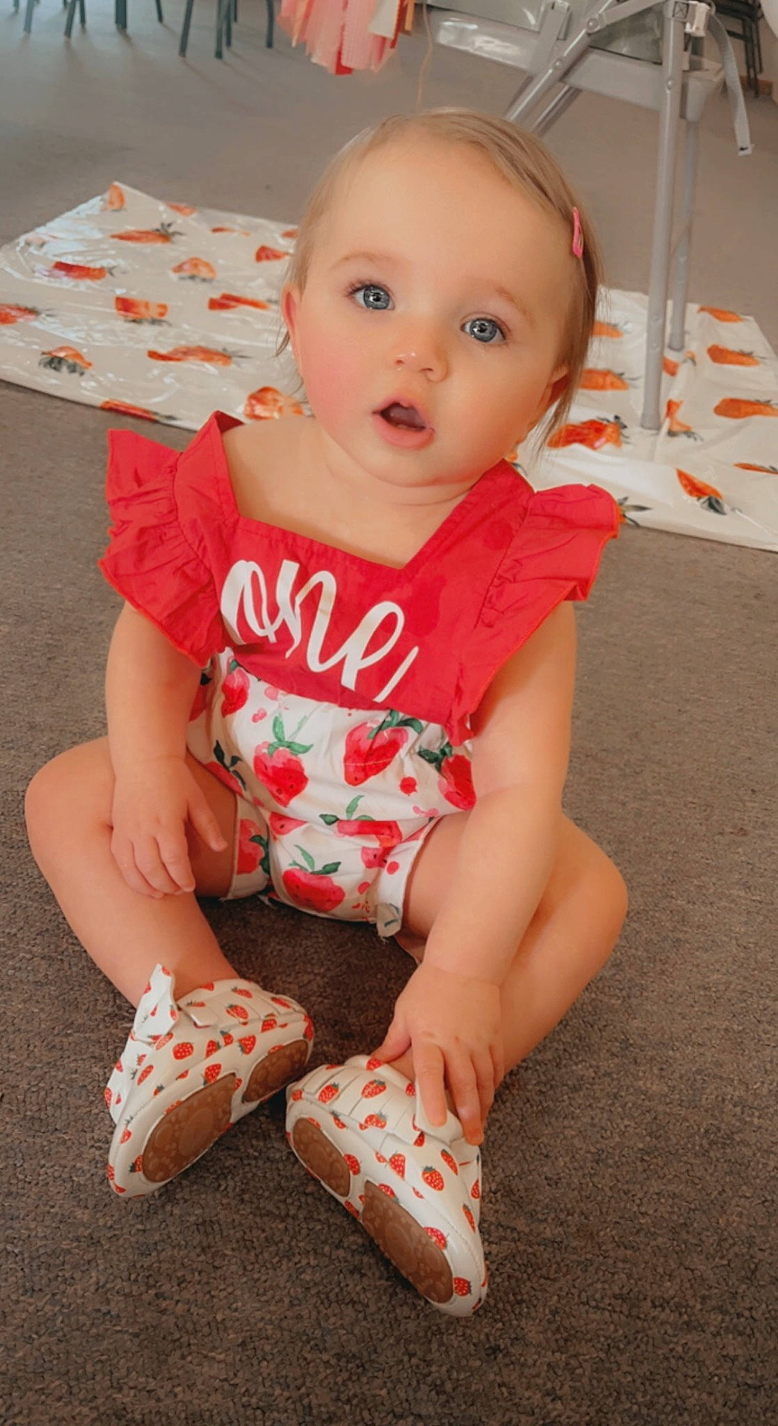 Bailee is registered to the contest to win money with this photo: arm, baby, baby_toddler_clothing, cheek, child, flooring, head, human_body, joint, knee, leg, orange, person, pink, red, skin, sleeve, standing, surprise, t_shirt