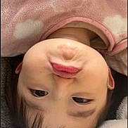 Lily joined the competition — help win amazing prizes! baby, child, face, pout, pink_clothing, fleece, cloud_pattern, blanket, cute, indoors, portrait, young_child, skin, head, expression, lying_down, cozy, infant, warm, soft