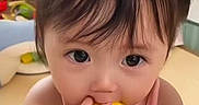 Lily joined the competition — help win amazing prizes! toddler, child, baby, eating, fruit, yellow, pigtails, curly_hair, indoors, toy, playroom, cute, small_hands, pink_clothing, curious_eyes, face, portrait, sitting, young_child, innocence