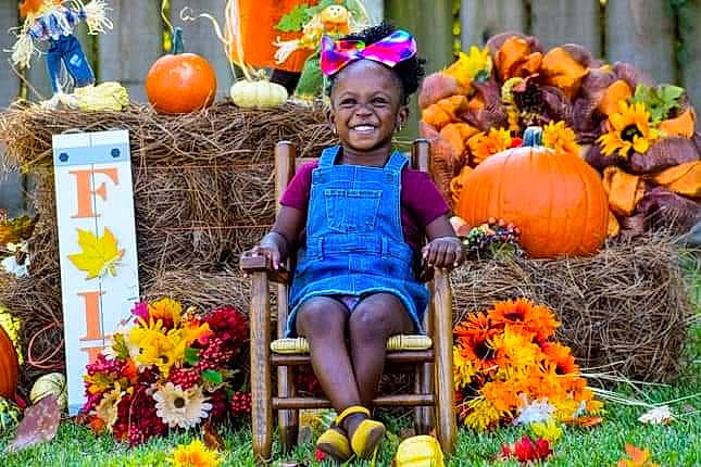 Aubree is registered to the contest to win money with this photo: botany, calabaza, community, cucurbita, flower, gourd, grass, happy, joy, natural_foods, orange, people, person, plant, public_space, pumpkin, shorts, smile, summer, whole_food