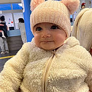 Ella Rachel participe au concours pour gagner de l'argent avec cette photo : baby, blue_pillar, child, closeup, cute, face, fluffy_clothing, happy, hat, headwear, indoor, infant, jacket, people, person, pom_poms, portrait, smile, toddler, warm_clothing