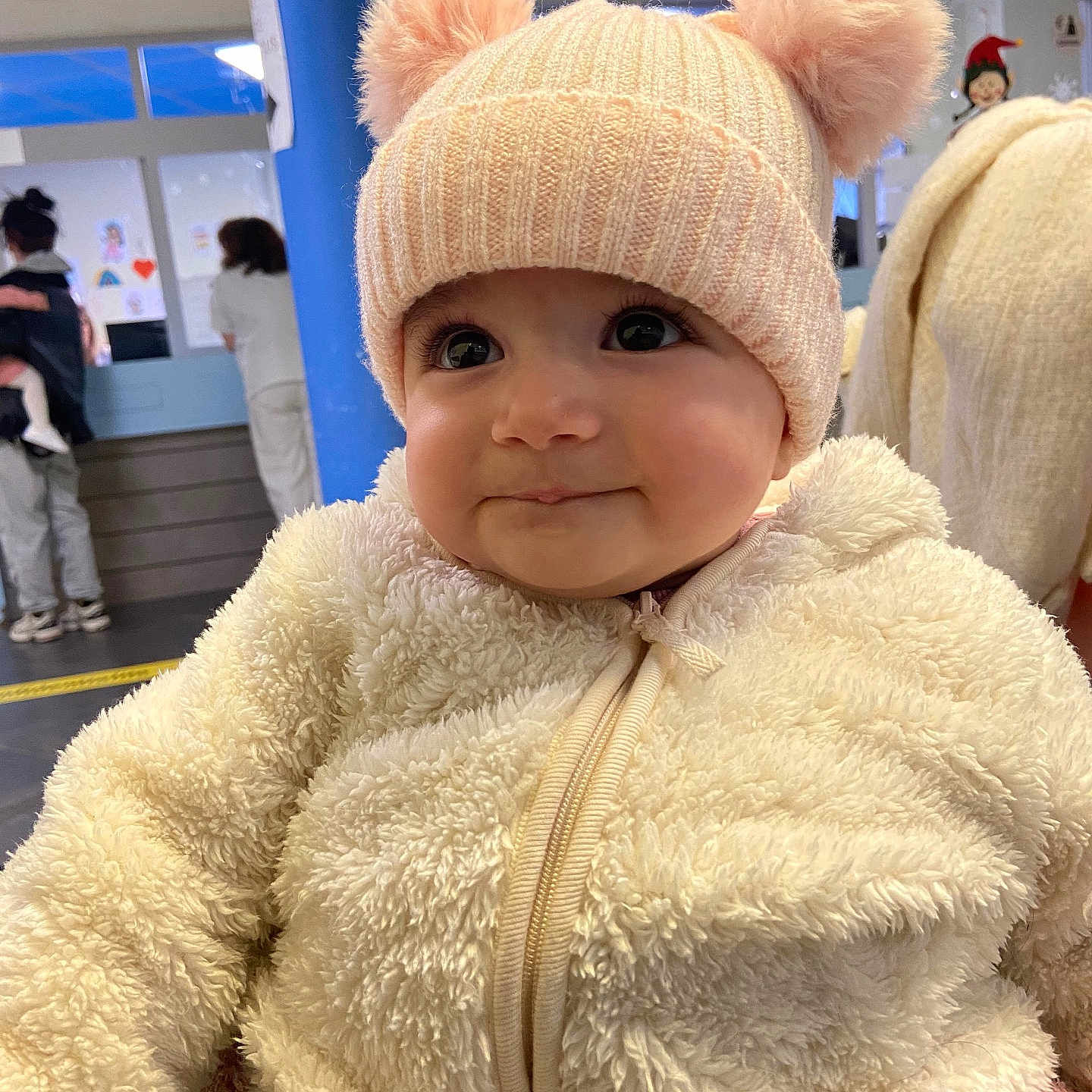 Ella Rachel participe au concours pour gagner de l'argent avec cette photo : baby, blue_pillar, child, closeup, cute, face, fluffy_clothing, happy, hat, headwear, indoor, infant, jacket, people, person, pom_poms, portrait, smile, toddler, warm_clothing