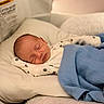 Easton is registered to the contest to win money with this photo: baby, bed, blanket, blue_blanket, child, comfort, cozy, cute, face, indoors, infant, newborn, onesie, paw_prints, peaceful, pillow, portrait, resting, sleeping, soft