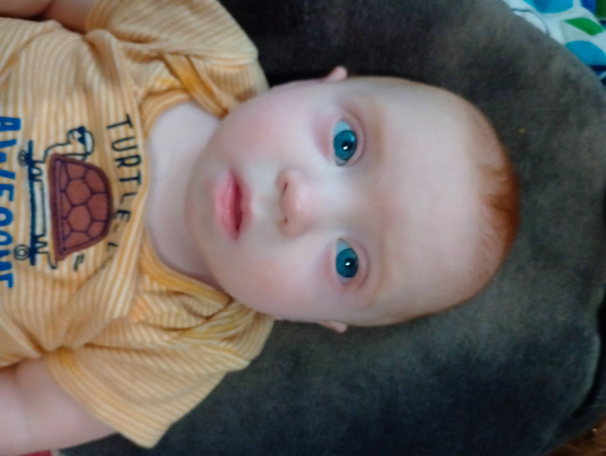 Elijah is registered to the contest to win money with this photo: baby, baby_toddler_clothing, cheek, child, eyebrow, eyelash, forehead, human_body, iris, lip, mammal, nose, organ, person, product, sitting, skin, textile, toddler, toy