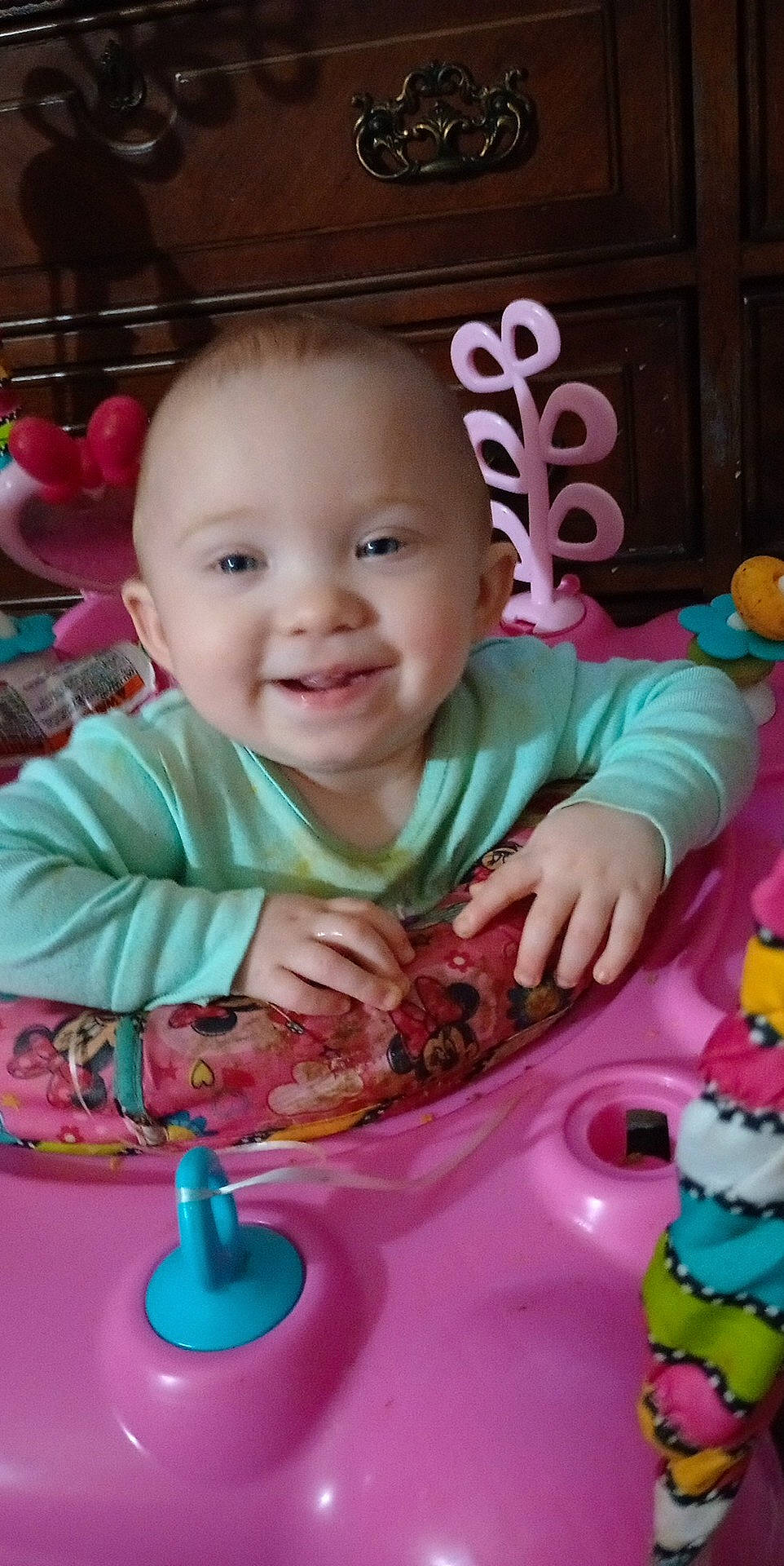 Ashley is registered to the contest to win money with this photo: baby, baby_toddler_clothing, baked_goods, cake, cake_decorating, chair, cheek, child, finger, food, fun, happy, person, pink, plate, skin, smile, sweetness, table, tableware