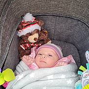 Libby-Rae joined the competition — help win amazing prizes! baby, blanket, stroller, teddy_bear, hat, toy, child, pink_jacket, face, bundle, cozy, infant, soft, cute, winter_wear, colorful, indoor, portrait, newborn, wrapped
