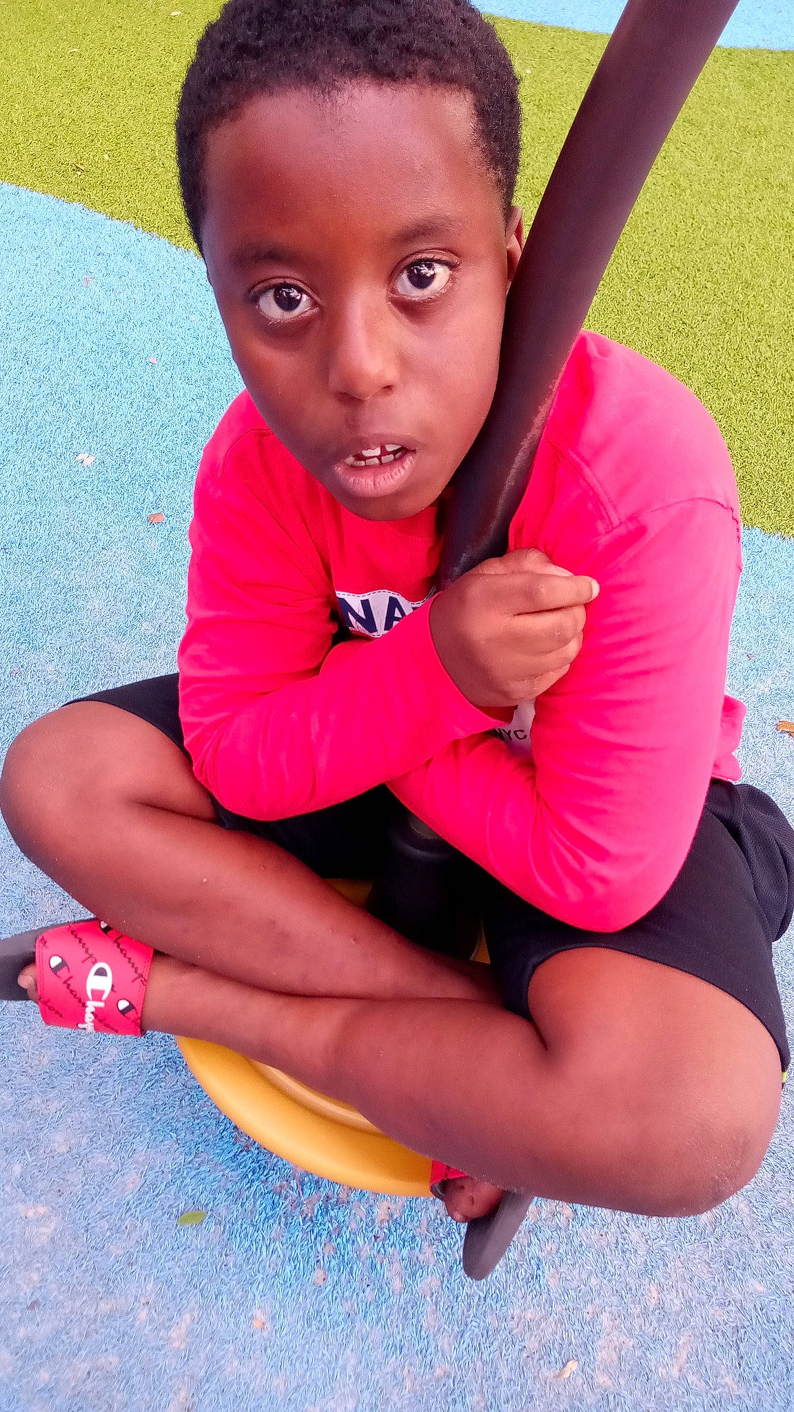 Amarrio is registered to the contest to win money with this photo: baby_toddler_clothing, black_hair, elbow, eye, facial_expression, finger, fun, grass, happy, head, joint, knee, leg, lip, neck, person, pink, red, skin, summer