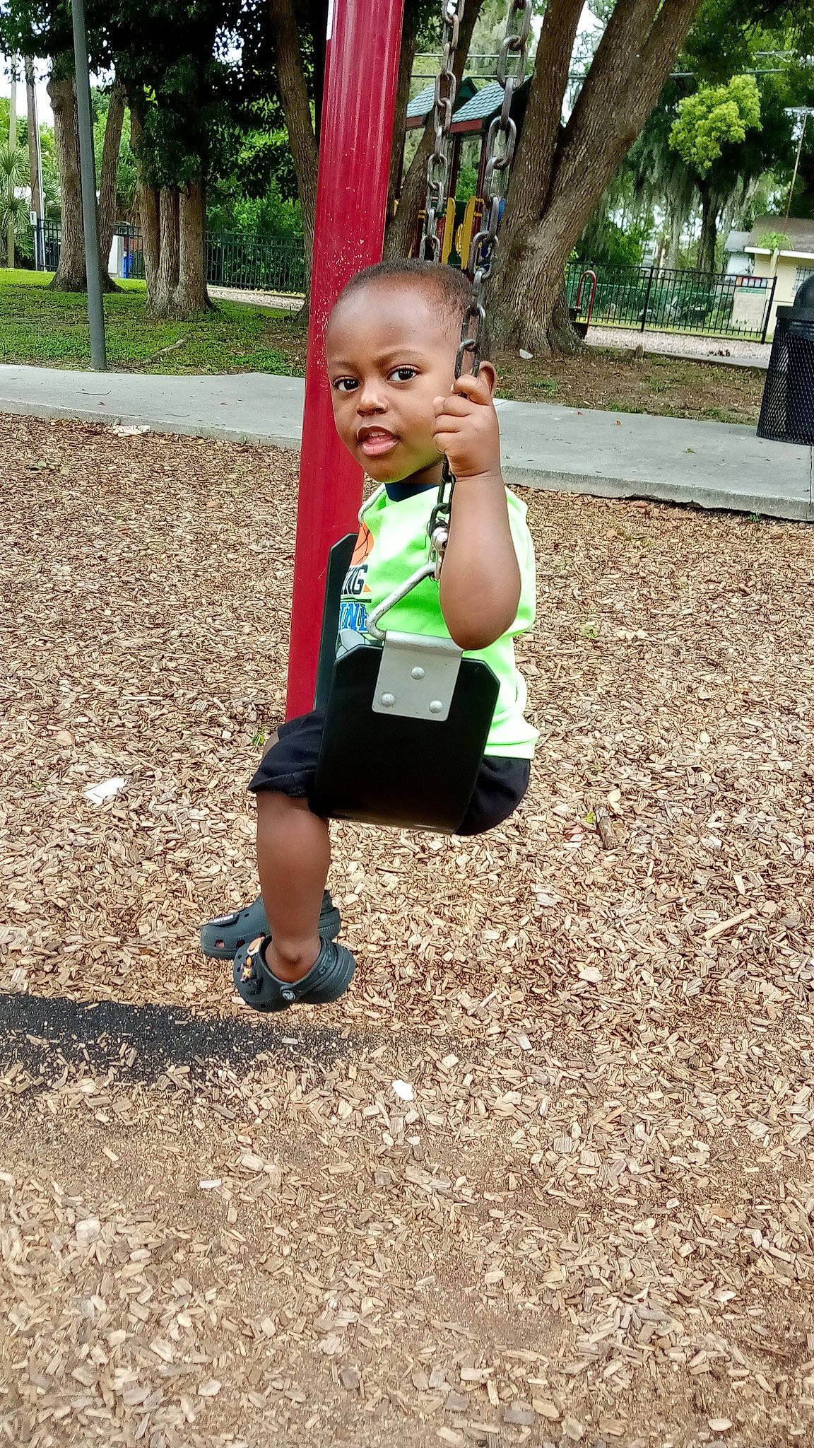 Quavii is registered to the contest to win money with this photo: child, city, eye, fun, grass, happy, leisure, outdoor_play_equipment, people_in_nature, person, plant, play, recreation, shade, shorts, sitting, smile, soil, t_shirt, toddler