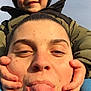 Noham a rejoint le concours — aidez-le/la à gagner de superbes lots ! adult, cheeks, child, closeup, expression, face, fun, hands, happy, hat, headwear, jacket, outdoor, person, playful, portrait, sky, smile, tongue, winter_clothing