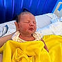 Harper is registered to the contest to win money with this photo: newborn, baby, blanket, yellow_blanket, bed, bedding, hand, resting, sleeping, infant, person, indoors, soft, peaceful, portrait, blue_background, clothing, cozy, newborn_baby, hospital_bed