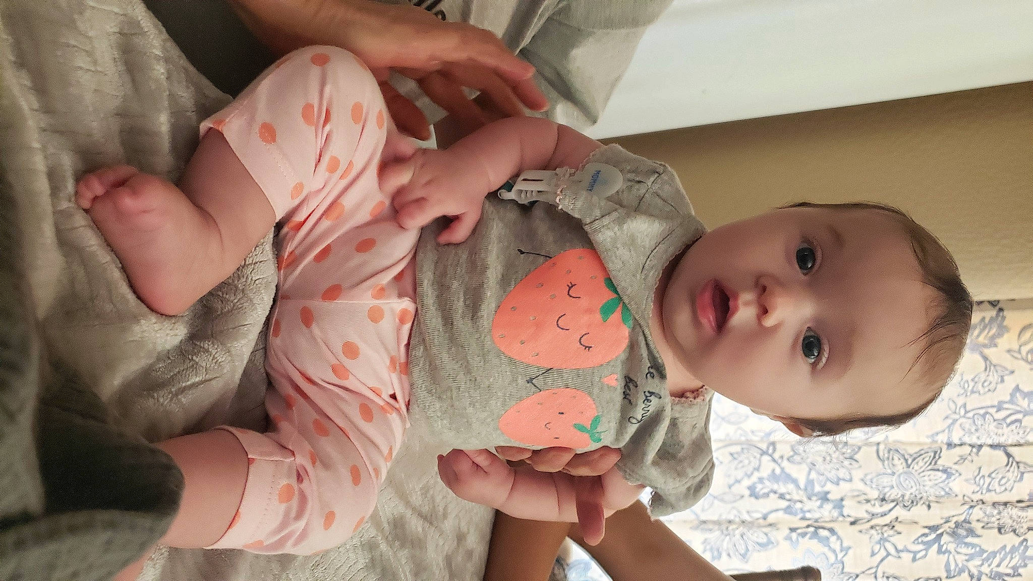 Alena is registered to the contest to win money with this photo: arm, baby, cheek, comfort, eye, facial_expression, finger, gesture, hand, head, human_body, joint, mammal, mouth, neck, nose, person, pink, skin, stomach