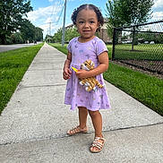 Adalyn joined the competition — help win amazing prizes! toddler, child, sidewalk, stuffed_toy, purple_dress, butterflies, sandals, smiling, curly_hair, outdoor, daytime, grass, trees, fence, suburban, person, happy, toy, summer, blue_sky