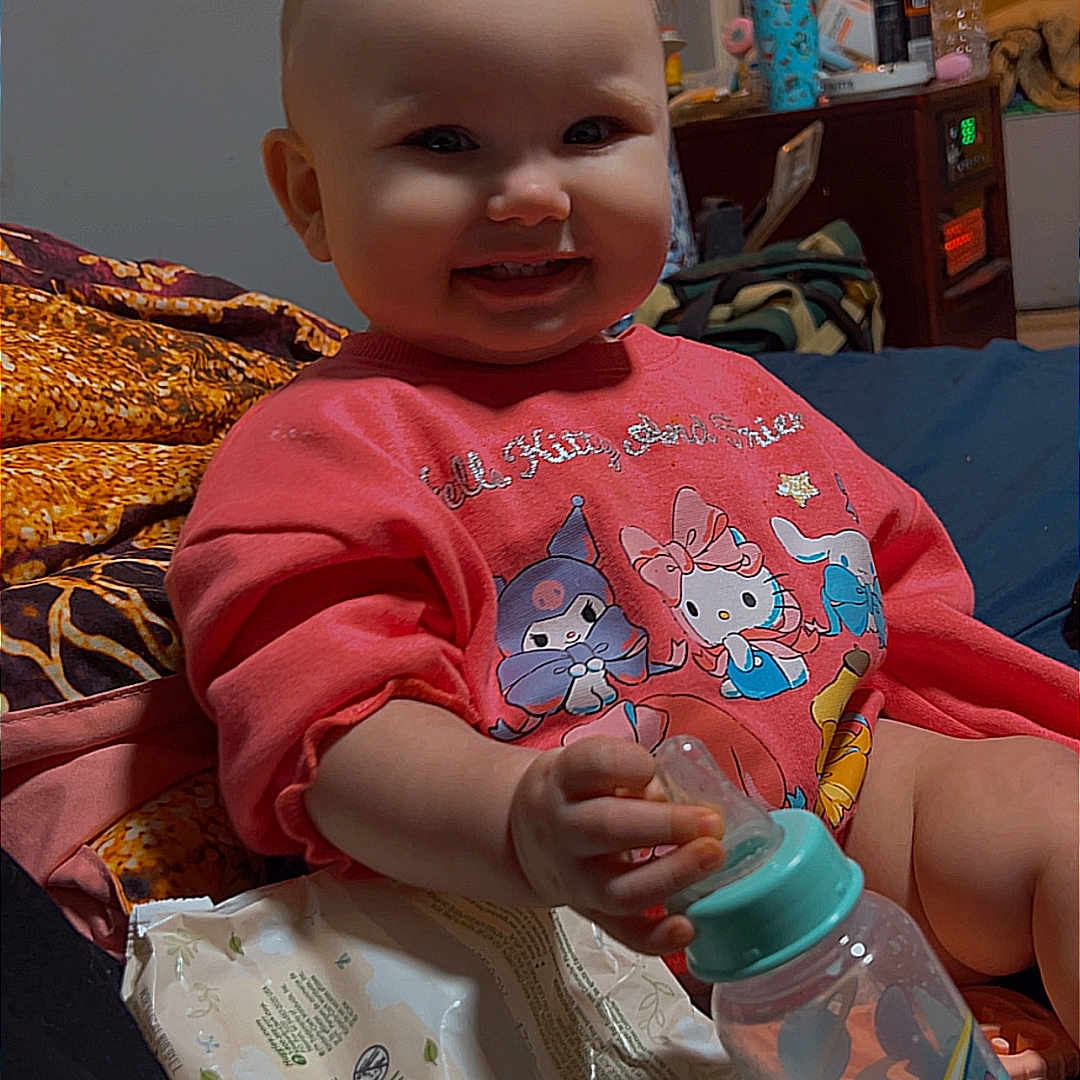 Aviahleigh is registered to the contest to win money with this photo: baby, bed, blanket, bottle, child, cute, dresser, indoors, infant, lamp, nightstand, pajamas, portrait, room, sippy_cup, smile, television, toy, water_bottle, wipes