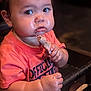 Izzak is registered to the contest to win money with this photo: toddler, child, food, chicken, messy, hands, face, high_chair, eating, curious, indoor, shirt, person, closeup, meal, table, mess, cute, baby, appetite
