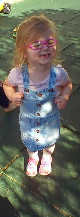 Felicity is registered to the contest to win money with this photo: baby_toddler_clothing, child, clothing, denim, dress, electric_blue, finger, gesture, grass, happy, joy, lip, pattern, people_in_nature, person, pink, shoulder, skin, sleeve, toddler