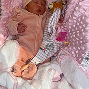 Kheylla participe au concours pour gagner de l'argent avec cette photo : newborn, baby, sleeping, pink_blanket, plush_toy, hat, soft_texture, infant_clothing, pacifier, blanket, bed, cozy, cute, peaceful, indoor, person, child, resting, wrapped, nursery