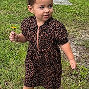 Megan is registered to the contest to win money with this photo: toddler, child, girl, leopard_print, dress, flower, grass, outdoor, nature, sandals, greenery, curly_hair, hair_bows, walking, happy, cute, summer, portrait, playful, young_child