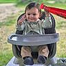 David joined the competition — help win amazing prizes! toddler, child, high_chair, toy, bat, balloon, smile, happy, clothing, shirt, suspenders, footwear, outdoor, greenery, table, face, person, baby, seat, play