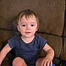David joined the competition — help win amazing prizes! barefoot, blue_toy, brown_couch, casual_clothing, child, couch, curious_expression, furniture, hair, home, indoor, light_skin, person, play, short_sleeve_shirt, sitting, toddler, toy, yellow_toy, young_child