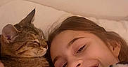 Baby joined the competition — help win amazing prizes! girl, child, smile, cat, tabby_cat, cuddle, bed, indoor, affection, happy, young, person, animal, pet, face, human, love, comfort, rest, casual