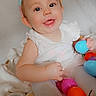 baby, bunny_ears, easter_eggs, smiling, child, white_clothing, toy, colorful, cute, indoors, portrait, happy, playful, hands, face, headwear, sitting, bright, festive, infant
